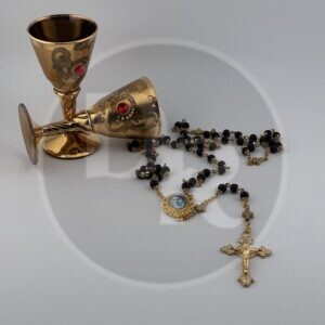 A black rosary for Catholics with a golden crucifix and centrepiece. The centrepiece has a small black and white photo of Saint Edith Stein